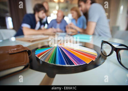 Samplers of colors on background of several designers working Stock Photo