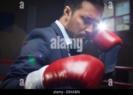 Asian businessman wearing red boxing gloves Stock Photo