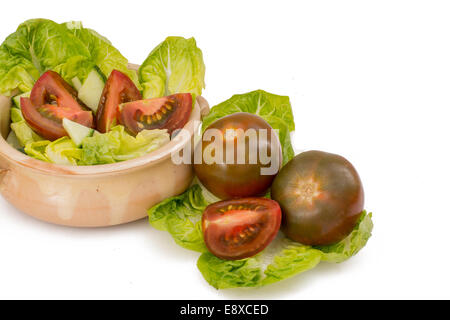 Black Tomatoes on an isolated white background. Stock Photo