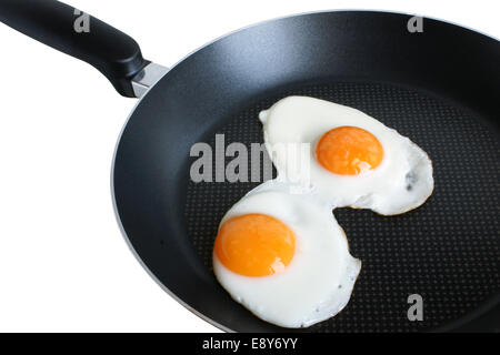 Fried eggs on griddle Stock Photo