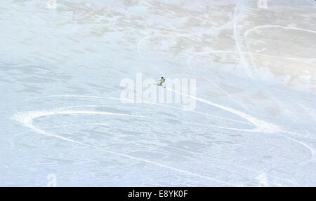 Ski trails cutting through Thin crust of ice over the snow in the spring in the mountains Stock Photo