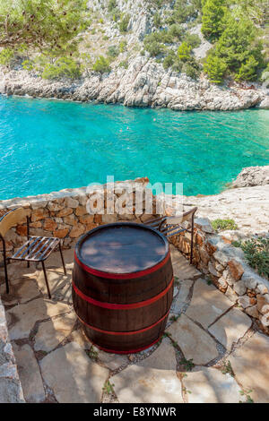 Barrel serving as table and chairs in Lucisca bay near Sveta Nedilja village, Hvar island, Croatia Stock Photo