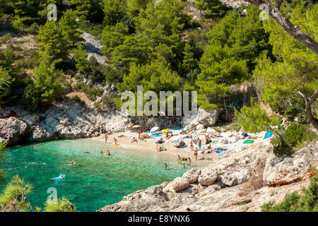 Tourists in Lucisca bay near Sveta Nedilja village, Hvar island, Croatia Stock Photo