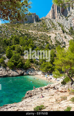 Tourists in Lucisca bay near Sveta Nedilja village, Hvar island, Croatia Stock Photo