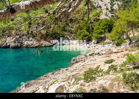 Tourists in Lucisca bay near Sveta Nedilja village, Hvar island, Croatia Stock Photo