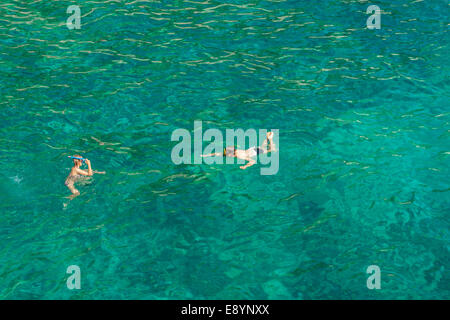 Tourists swimming in Lucisca bay near Sveta Nedilja village, Hvar island, Croatia Stock Photo