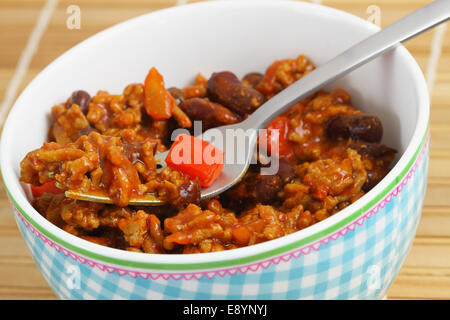 Chili con carne in porcelain bowl, close up Stock Photo