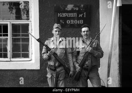 A soldiers posing with guns. The inscription in Russian: Russian Defence Ministry. Guard №1, the number of military unit 02018. Stock Photo