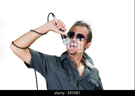 Young european rock singer wearing sunglasses on the white background Stock Photo