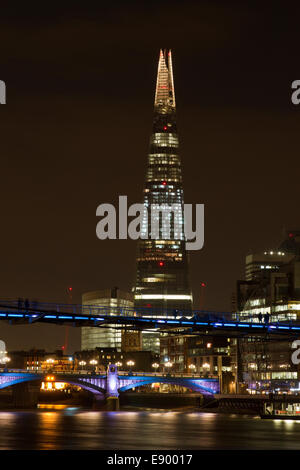 The Shard in London, England with the Millennium Bridge in the foreground. The bridge in the background is Southwark Bridge. Stock Photo