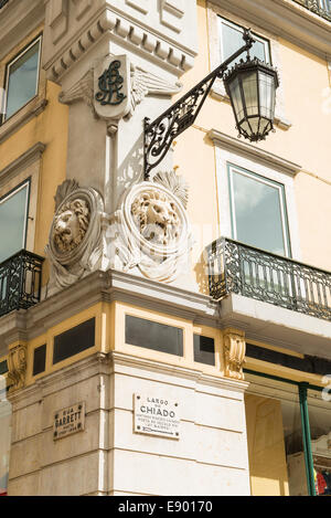 Portugal Lisbon Bairro Alto Largo do Chiado corner street corner , balcony , lamp light lion relief heads wall building detail Stock Photo