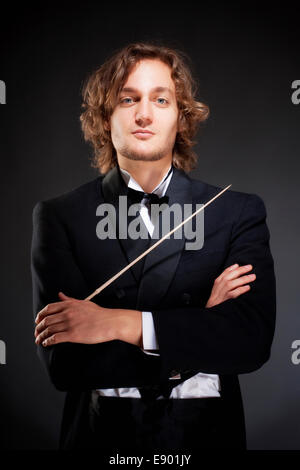 Portrait of a Young Conductor Holding a  Baton. Stock Photo