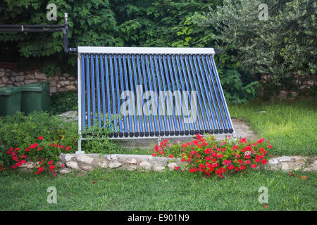 Vacuum solar water heating system in the yard house Stock Photo