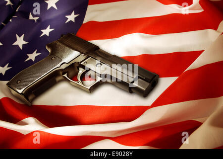 Handgun lying on American flag Stock Photo