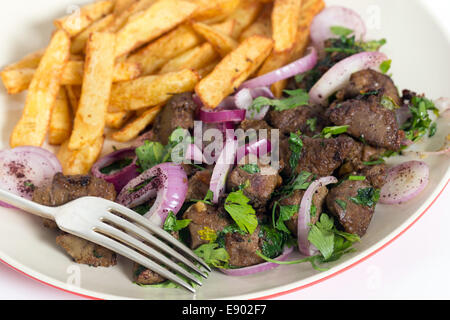 Albanian Liver, a traditional Turkish spiced lamb's liver recipe popular throughout the Middle East, with french fried potato ch Stock Photo