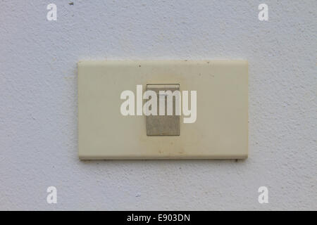 Light switch on the old wall cement Stock Photo