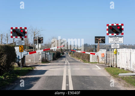 Closing barriers at the level crossing at Ufton Nervet, Berkshire, England, UK. Stock Photo
