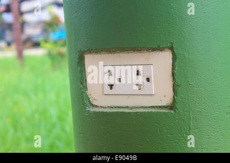 plug the power electrical mounted on stone poles Stock Photo