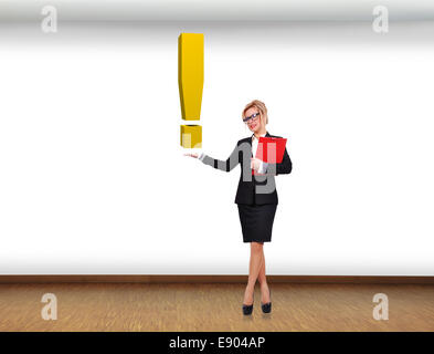 businesswoman holding big gold  exclamation mark in room Stock Photo