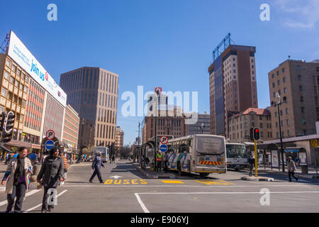 JOHANNESBURG, SOUTH AFRICA - Pedestrians and buses in city centre. Stock Photo