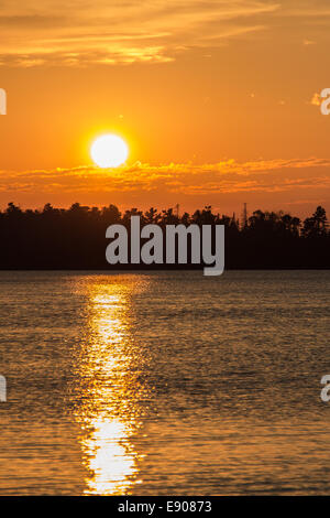 Evening sunset over water in the Northwoods of Upper Michigan. Stock Photo