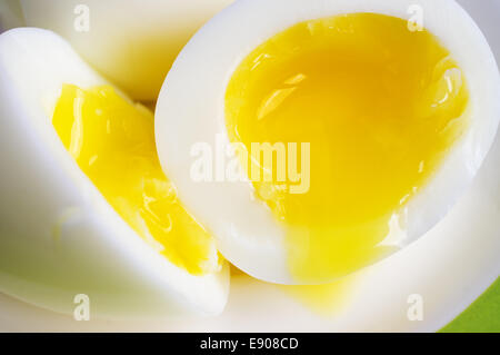 Two soft-boiled eggs on a plate, one half Stock Photo