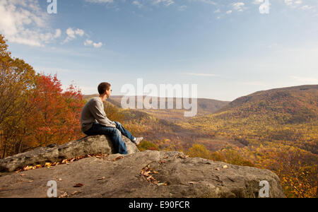 Young hiker relaxing on rock Stock Photo