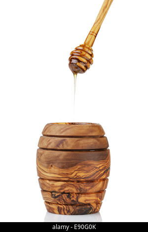 wooden honey pot with dipper, isolated on white background Stock Photo