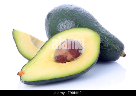 Ripe sliced avocado fruits isolated on white Stock Photo