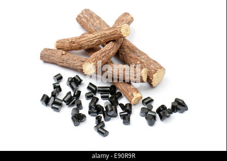 liquorice roots with black pieces, on white background Stock Photo