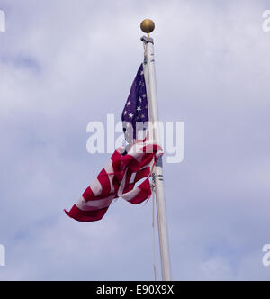 US Flag tied in a knot on pole Stock Photo