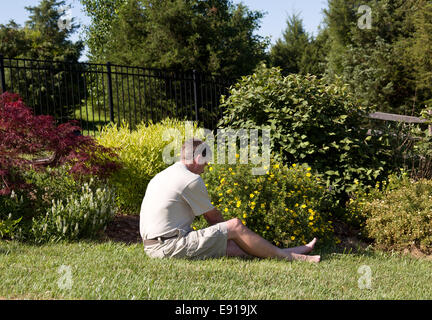 Senior man digging in garden Stock Photo