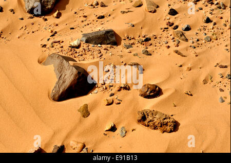 Rocks in wind blown desert sands Stock Photo