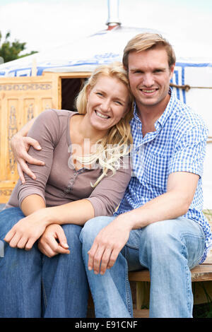 Couple Enjoying Camping Holiday In Traditional Yurt Stock Photo