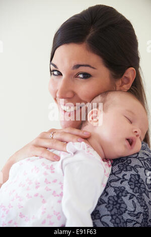 Mother Cuddling Sleeping Baby Daughter Stock Photo