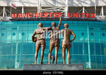 Old Trafford, Manchester, Greater Manchester, England. United Trinity statue outside the Manchester United football stadium. Stock Photo