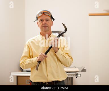 Man wearing balaclava and holding crowbar Stock Photo - Alamy