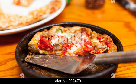 Deep dish pizza in metal serving dish Stock Photo