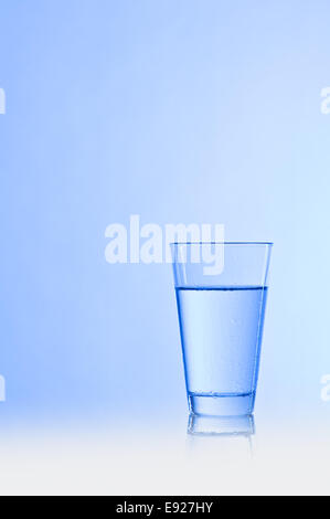 Water glass with a blue background