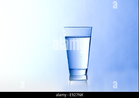 Water glass with a blue background