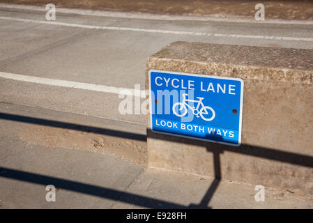 Blue cycle path lane sign by beach Stock Photo