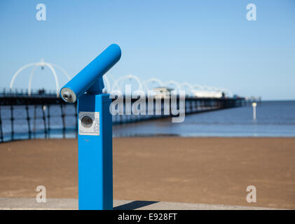 Blue telescope by blurred Southport pier Stock Photo