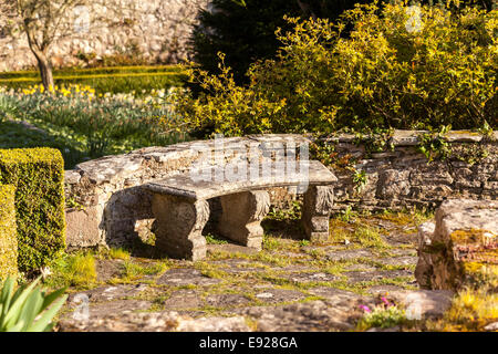 Old stone carved bench in garden Stock Photo