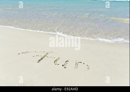 Fun written in the sand Stock Photo