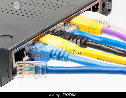 Cat 5 cables in multiple colors in router Stock Photo