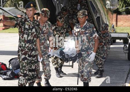 Kathmandu, Nepal. 17th Oct, 2014. Nepalese Army personnel bring the bodies of avalanche victims in Kathmandu, Nepal, Oct. 17, 2014. The death toll from snow blizzards in northern Nepal will probably climb to 50 as more than 100 people are still missing, Trekking Agencies Association of Nepal (TAAN) said here Friday. Credit:  Nepal Army/Xinhua/Alamy Live News Stock Photo