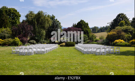 Rows of wooden chairs set up for wedding Stock Photo