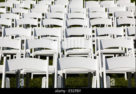 Rows of wooden chairs set up for wedding Stock Photo