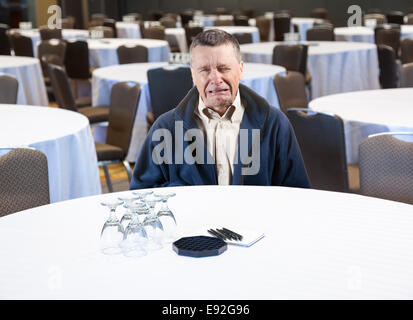 Man crying in empty conference room Stock Photo