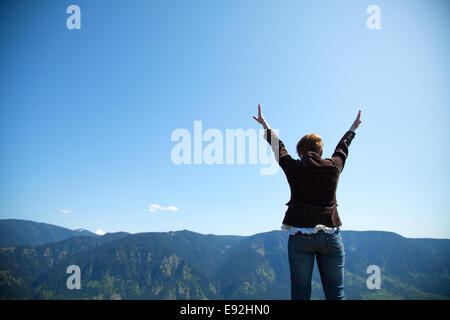 Woman with raised hands Stock Photo